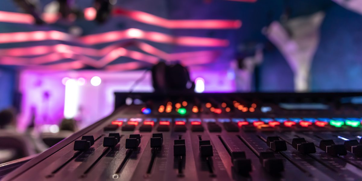 Sound mixer. Professional audio mixing console with lights, buttons, faders and sliders.